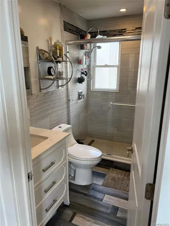 a bathroom with a toilet and a shower