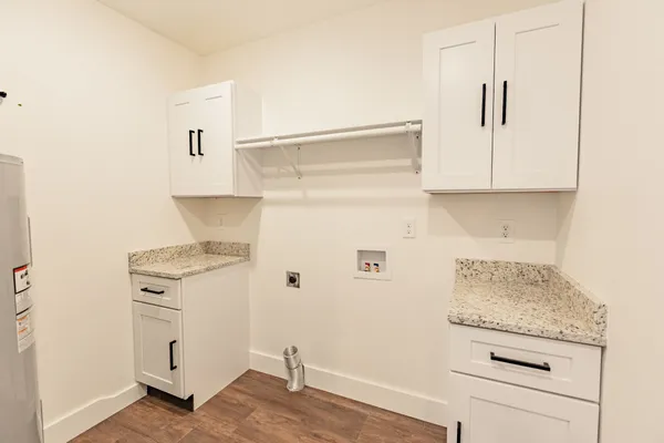 a kitchen with white cabinets and white appliances