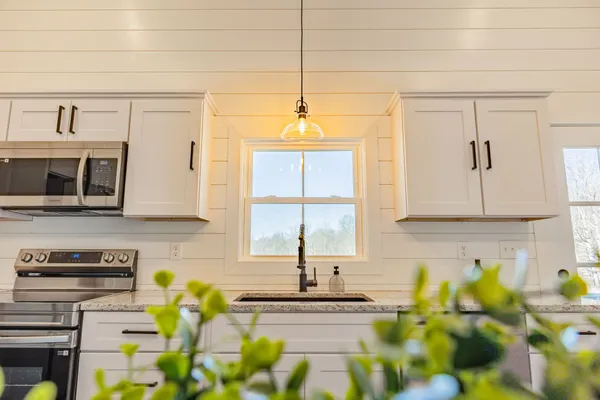 a kitchen with a sink and a stove top oven