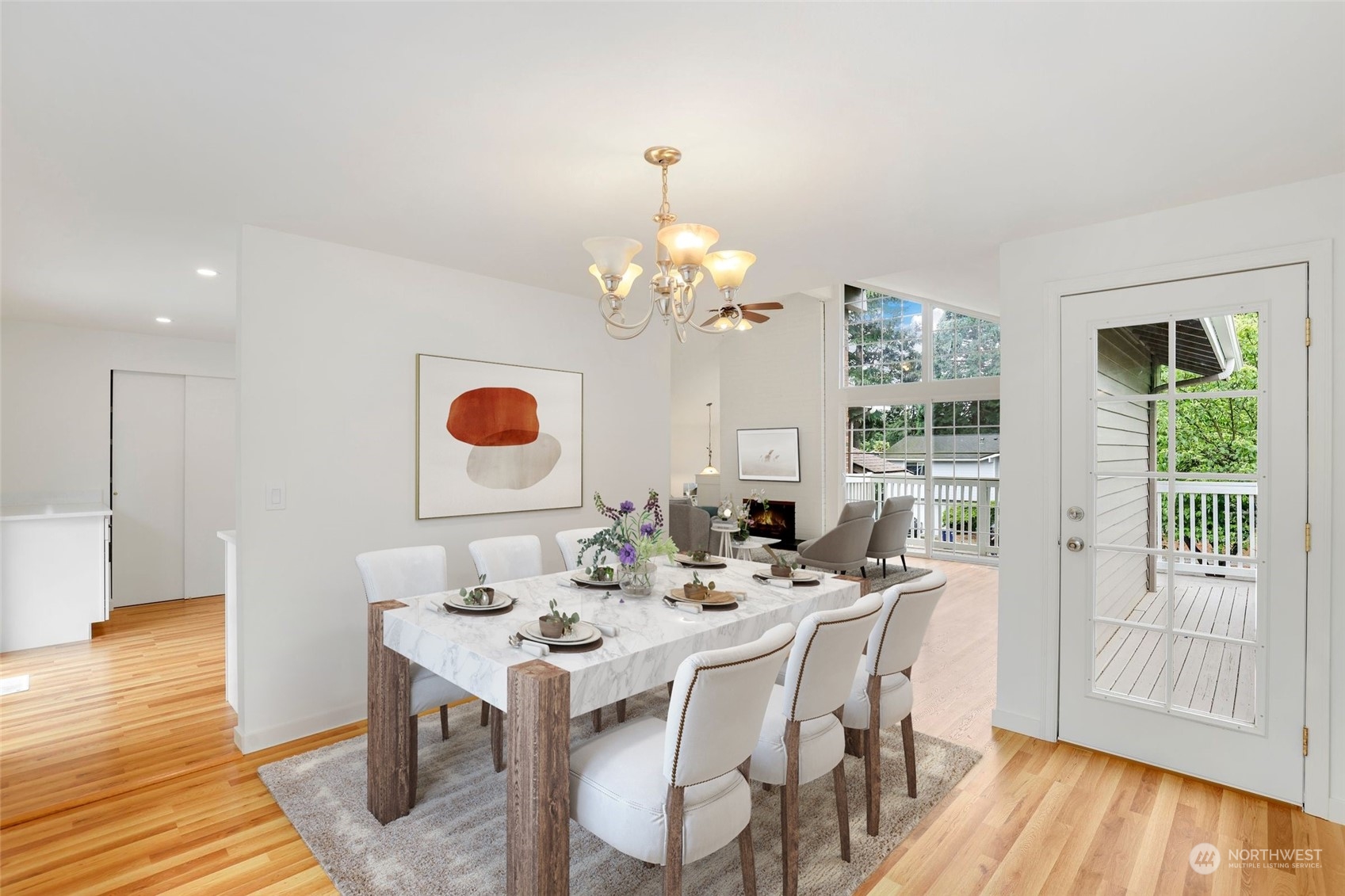 3672 Southwest 318th Street Federal Way, WA 98023 - Photo 6 of 40 a dining room with wooden floor a chandelier a glass table and chairs
