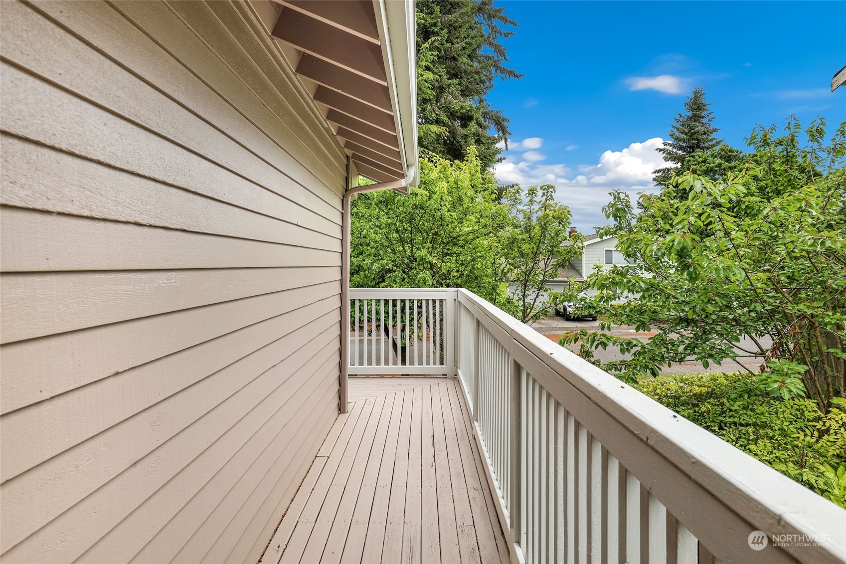 3672 Southwest 318th Street Federal Way, WA 98023 - Photo 7 of 40 a balcony with wooden floor and trees in the back