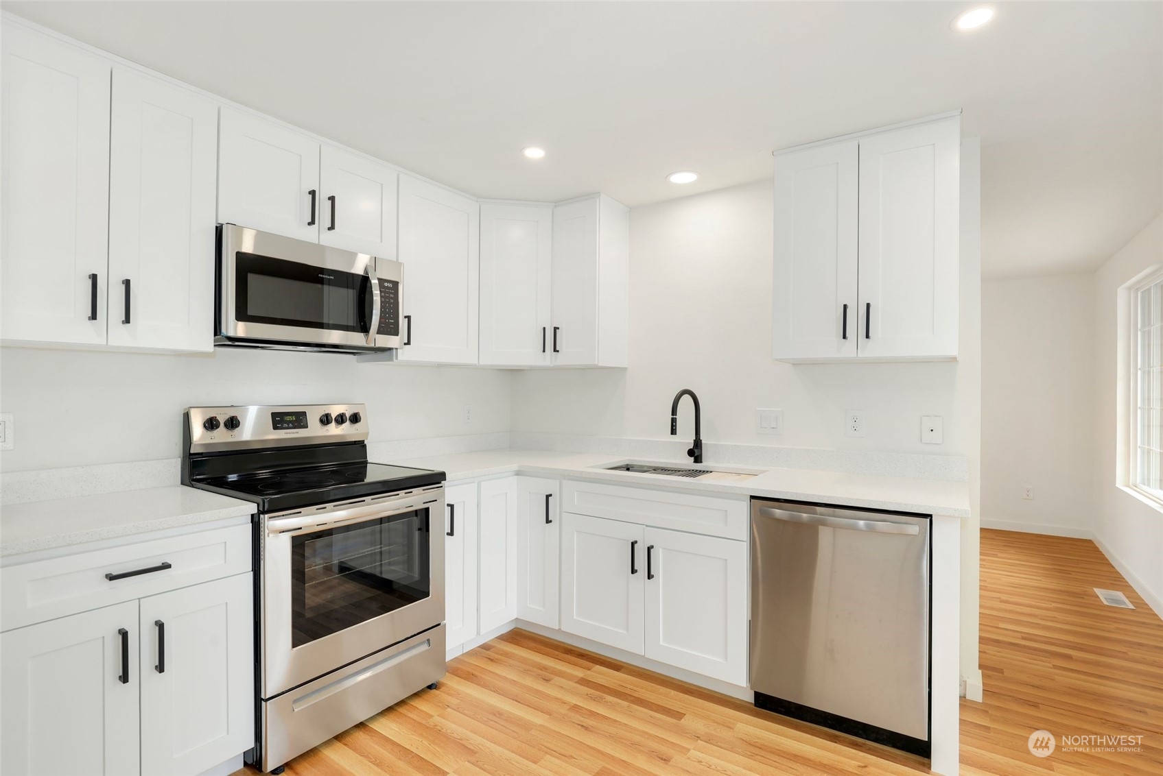 3672 Southwest 318th Street Federal Way, WA 98023 - Photo 9 of 40 a kitchen with white cabinets stainless steel appliances and sink