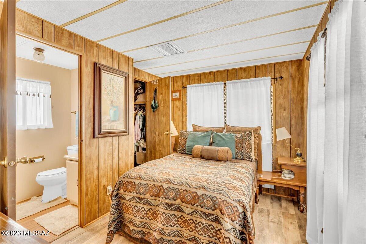5379 West Rafter Cir Street Tucson, AZ 85713 - Photo 23 of 38 a bedroom with a bed and wooden floor
