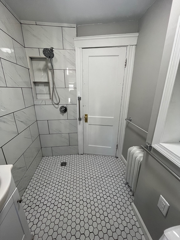 a bathroom with a glass door shower