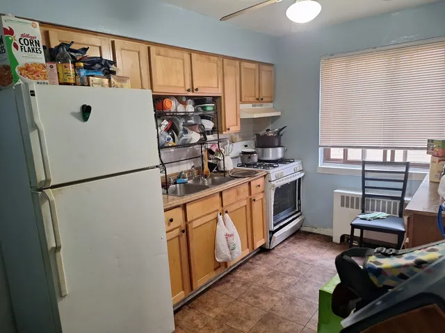 a kitchen with stainless steel appliances a refrigerator sink and cabinets