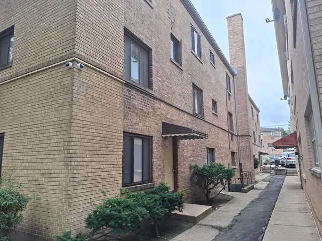 a view of a building with potted plants