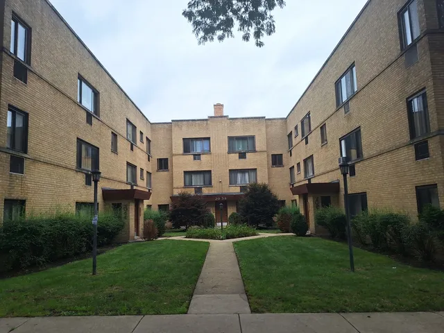 a front view of a building with a yard