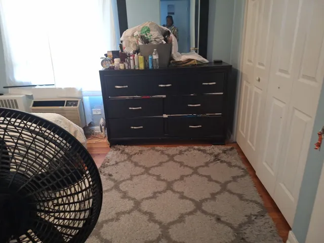 a room with a dresser and a mirror