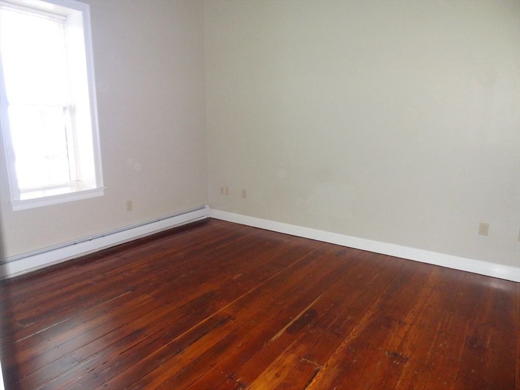 25 Main Street, Unit 3A Ayer, MA 01432 - Photo 7 of 7 an empty room with wooden floor and windows