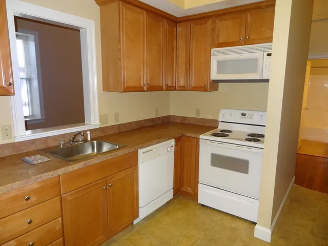 a utility room with sink dryer and washer