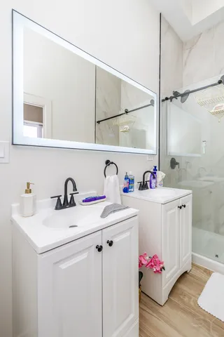 a large kitchen with stainless steel appliances granite countertop a stove a sink and a refrigerator