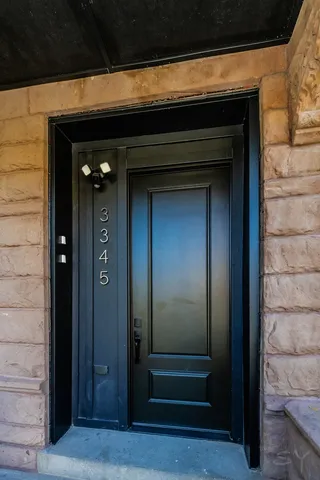 a large white kitchen with kitchen island a refrigerator a stove a sink dishwasher a oven with a dining table and chairs with wooden floor