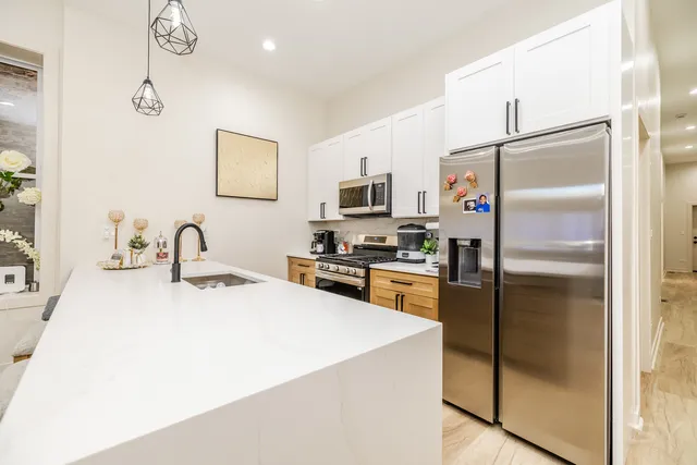 a kitchen with stainless steel appliances granite countertop a stove and a sink