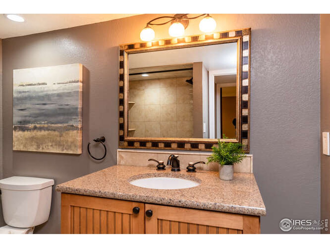 7177 Four Rivers Road Boulder, CO 80301 - Photo 15 of 32 a bathroom with a granite countertop sink and a mirror