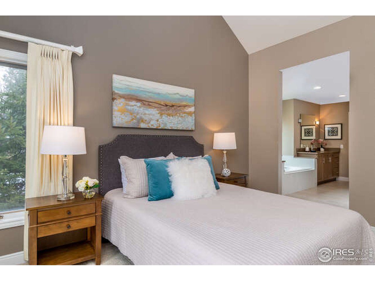 7177 Four Rivers Road Boulder, CO 80301 - Photo 17 of 32 a bedroom with a bed and a lamp