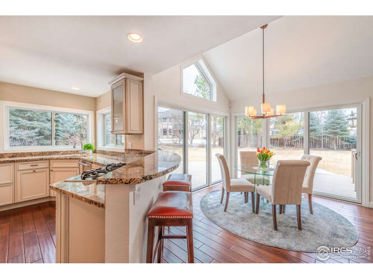 7177 Four Rivers Road Boulder, CO 80301 - Photo 6 of 32 a dining room with furniture a large window and a chandelier