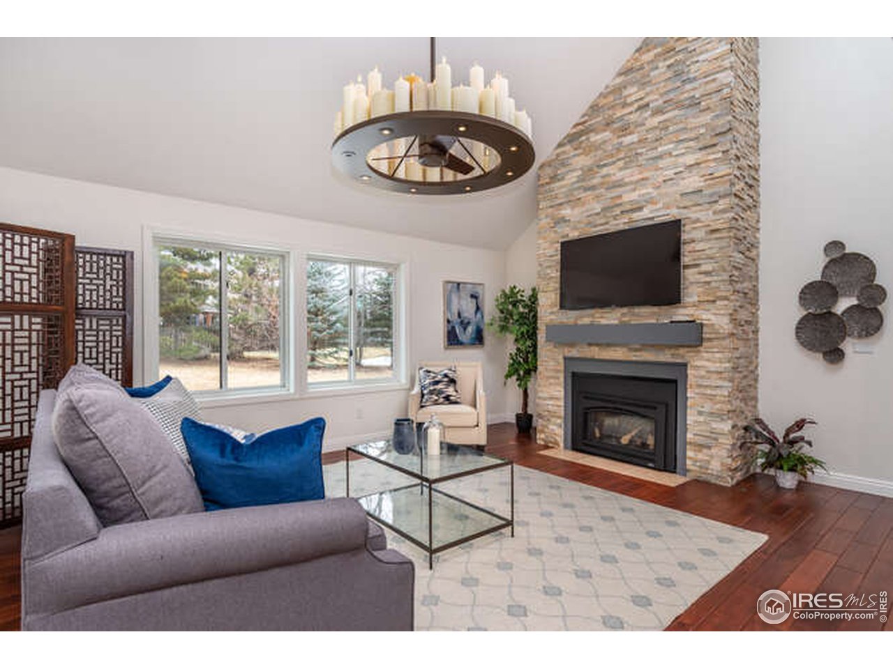 7177 Four Rivers Road Boulder, CO 80301 - Photo 10 of 32 a living room with furniture a flat screen tv and a fireplace