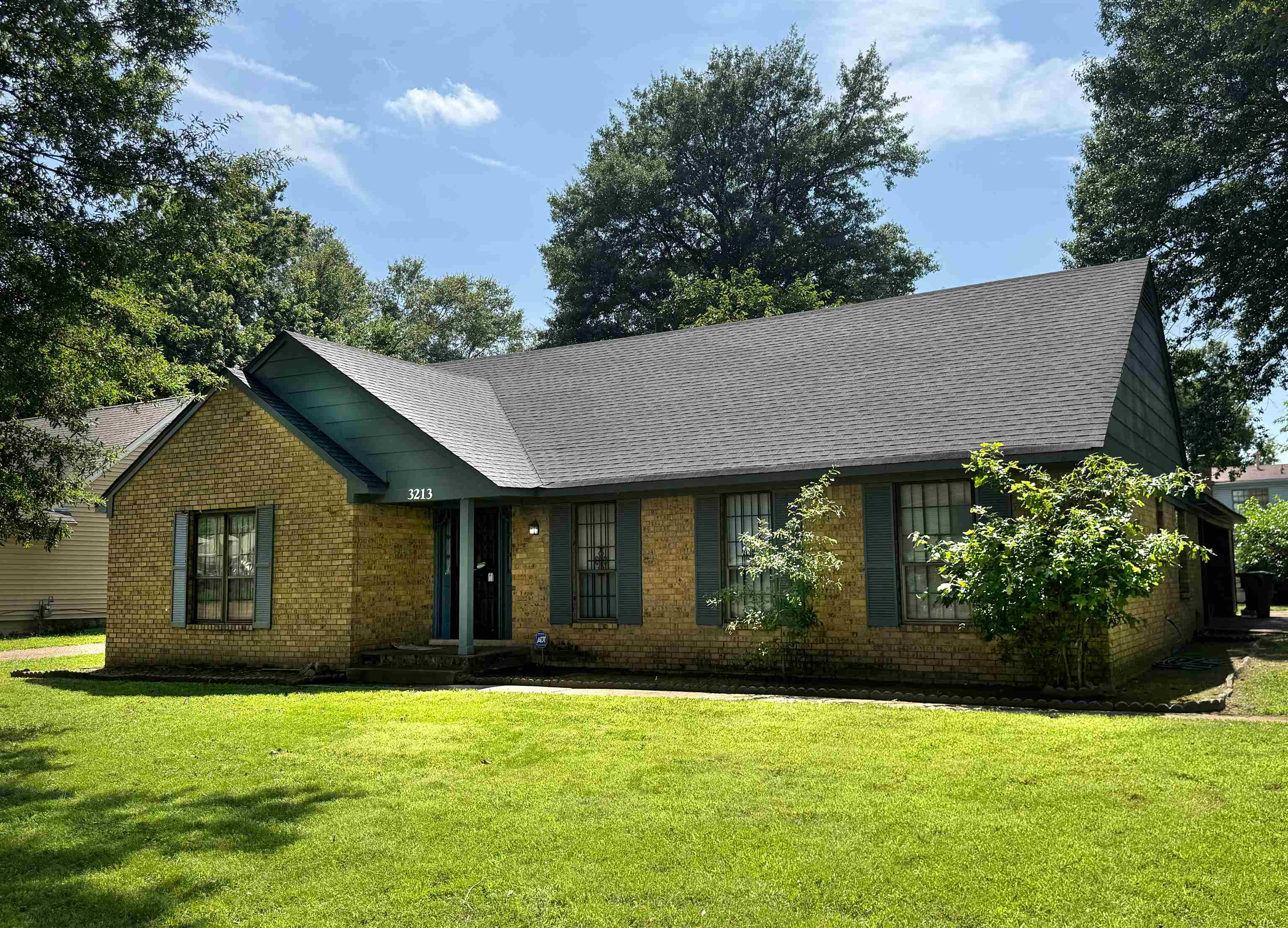 a front view of a house with a garden