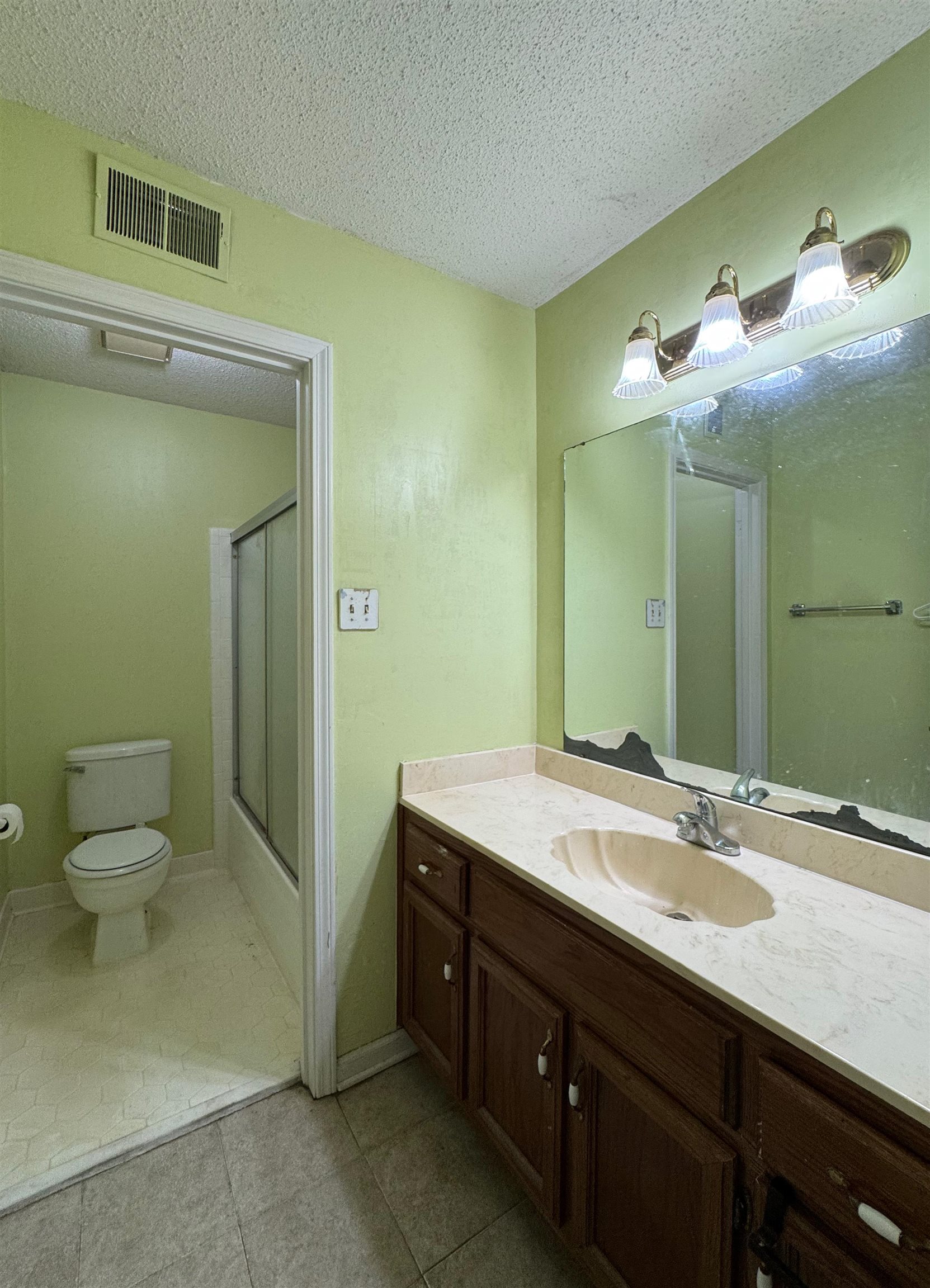 3213 Covington Pike Memphis, TN 38128 - Photo 14 of 17 a bathroom with a sink and a mirror