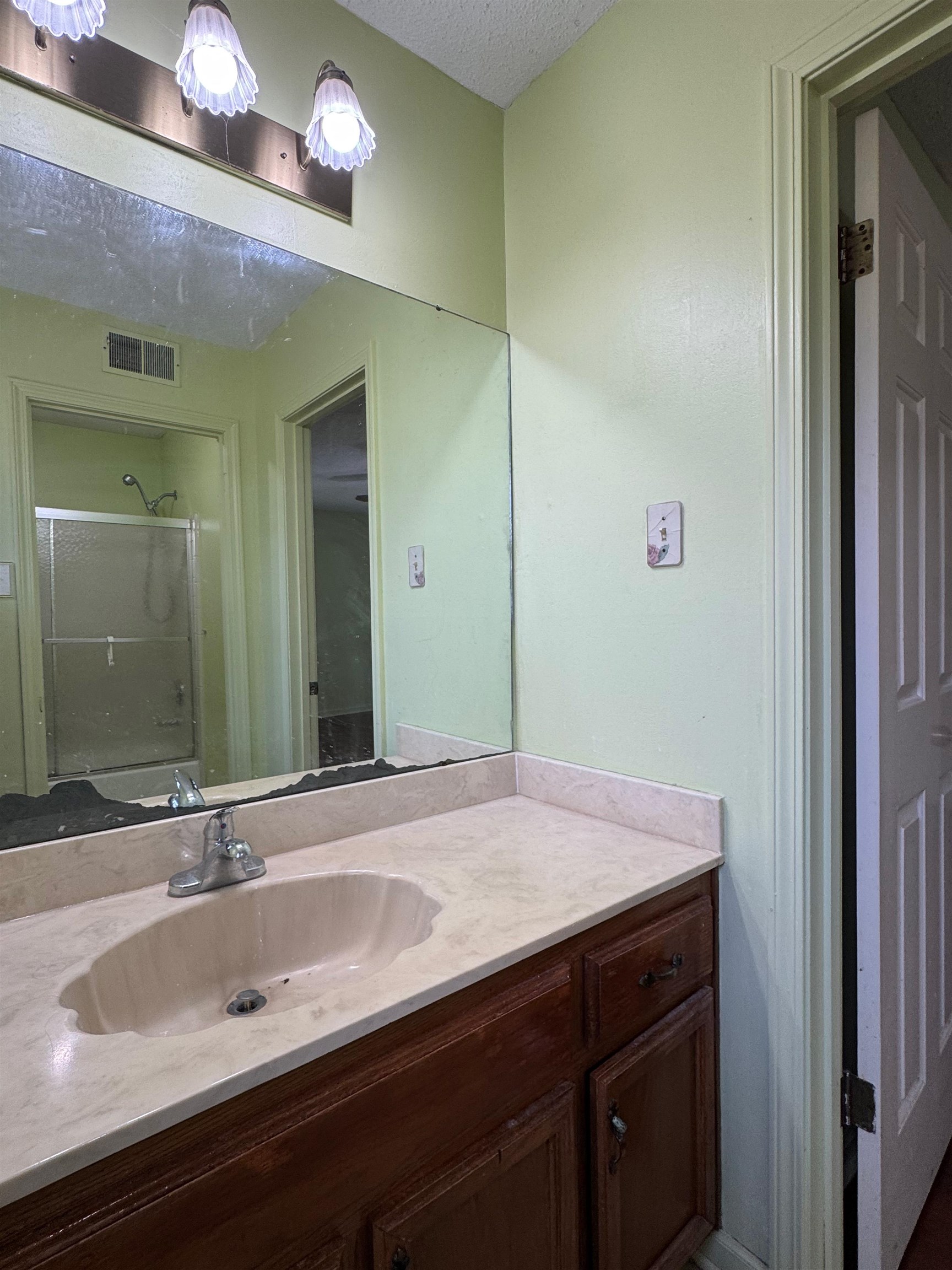 3213 Covington Pike Memphis, TN 38128 - Photo 15 of 17 a bathroom with a sink and a mirror