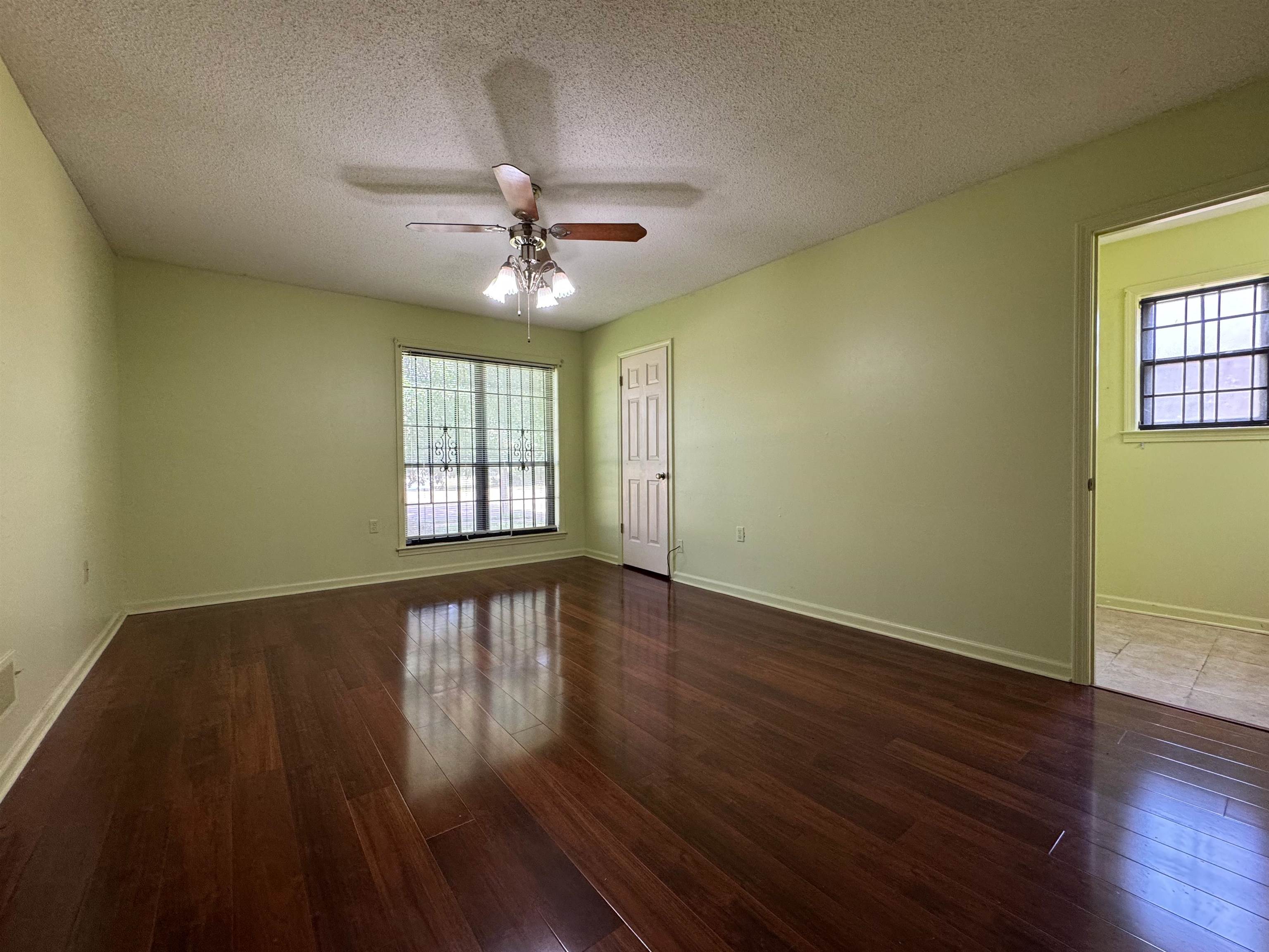 3213 Covington Pike Memphis, TN 38128 - Photo 16 of 17 a view of an empty room with wooden floor and a window