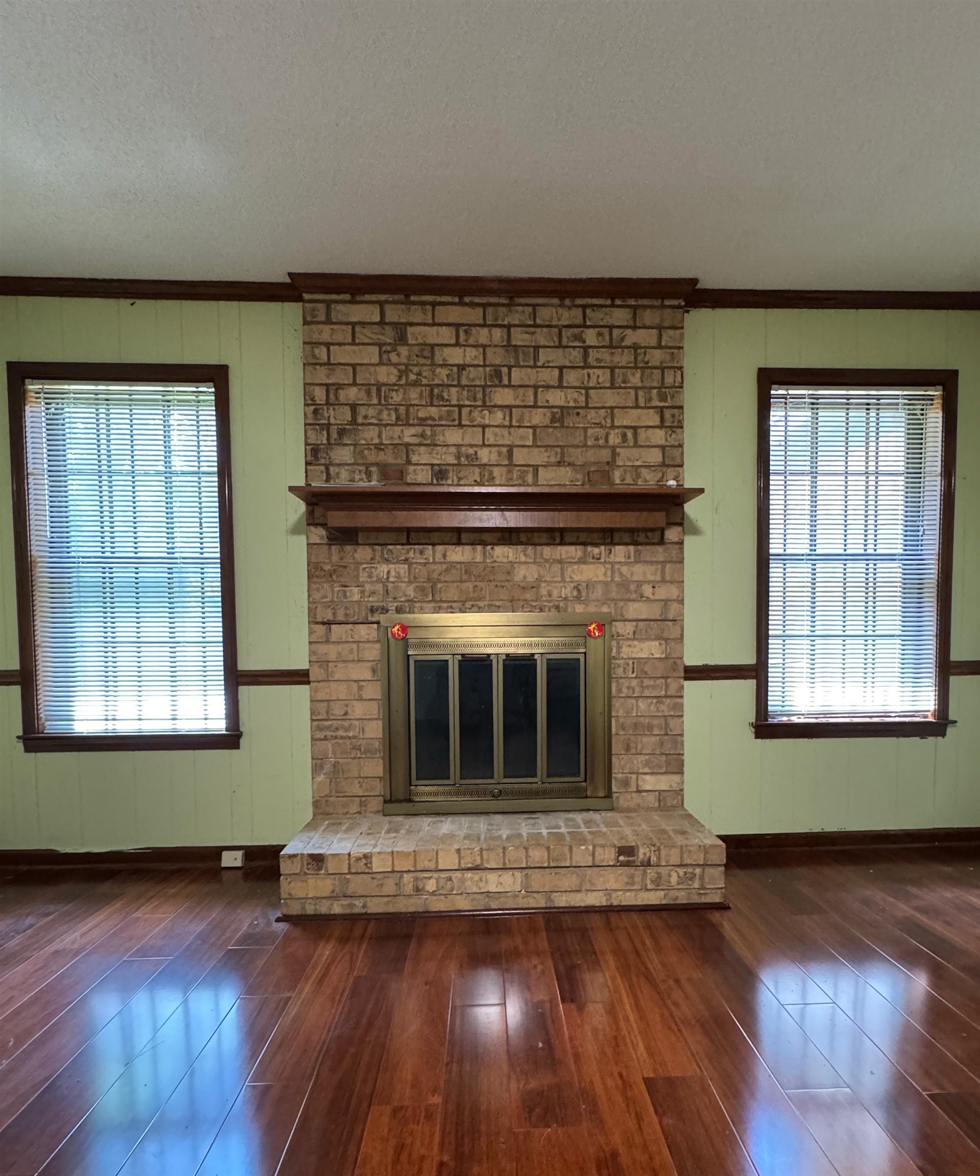 3213 Covington Pike Memphis, TN 38128 - Photo 4 of 17 a living room with a fireplace and wooden floor