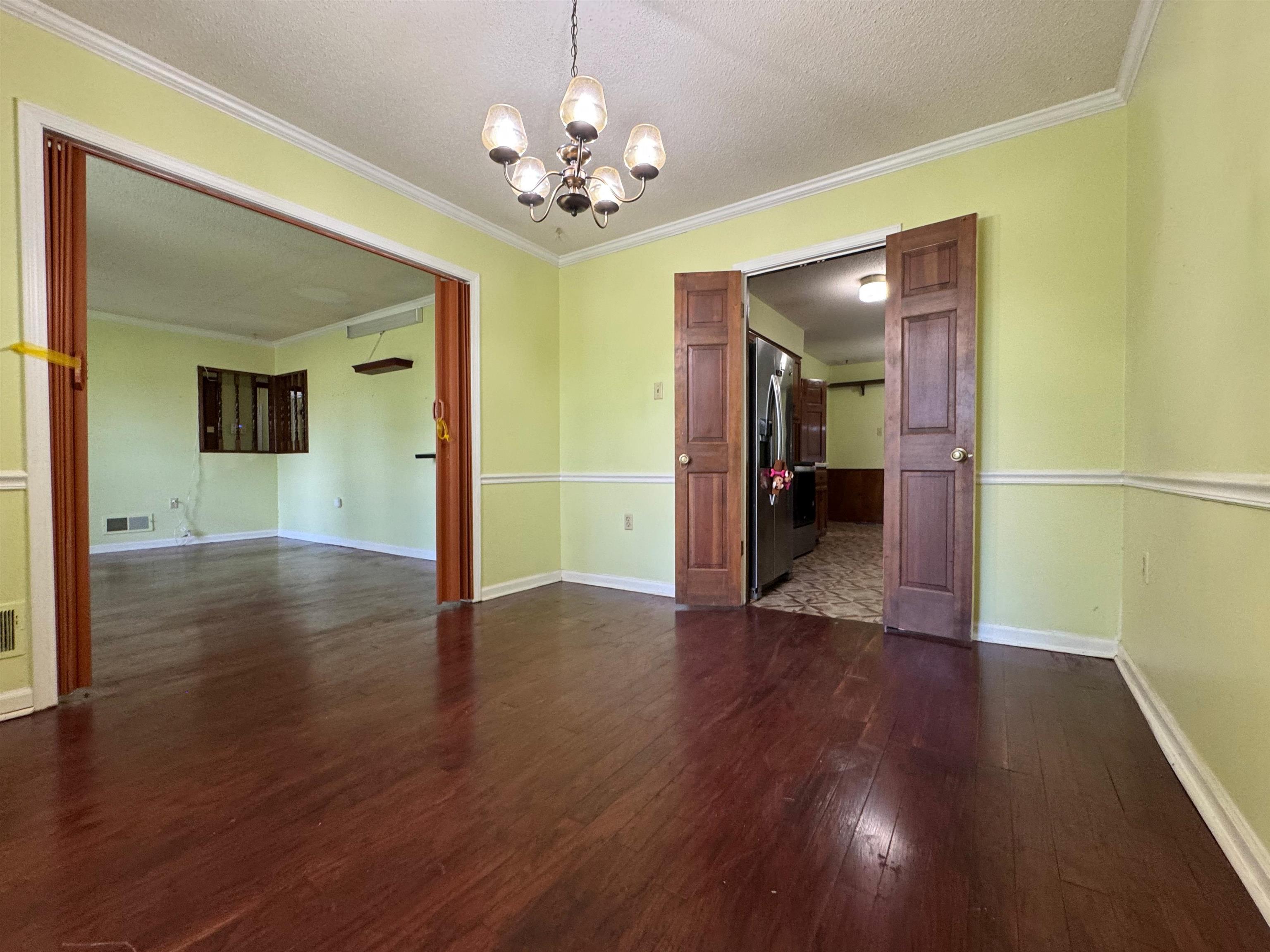 3213 Covington Pike Memphis, TN 38128 - Photo 6 of 17 a view of a hallway with wooden floor and chandelier