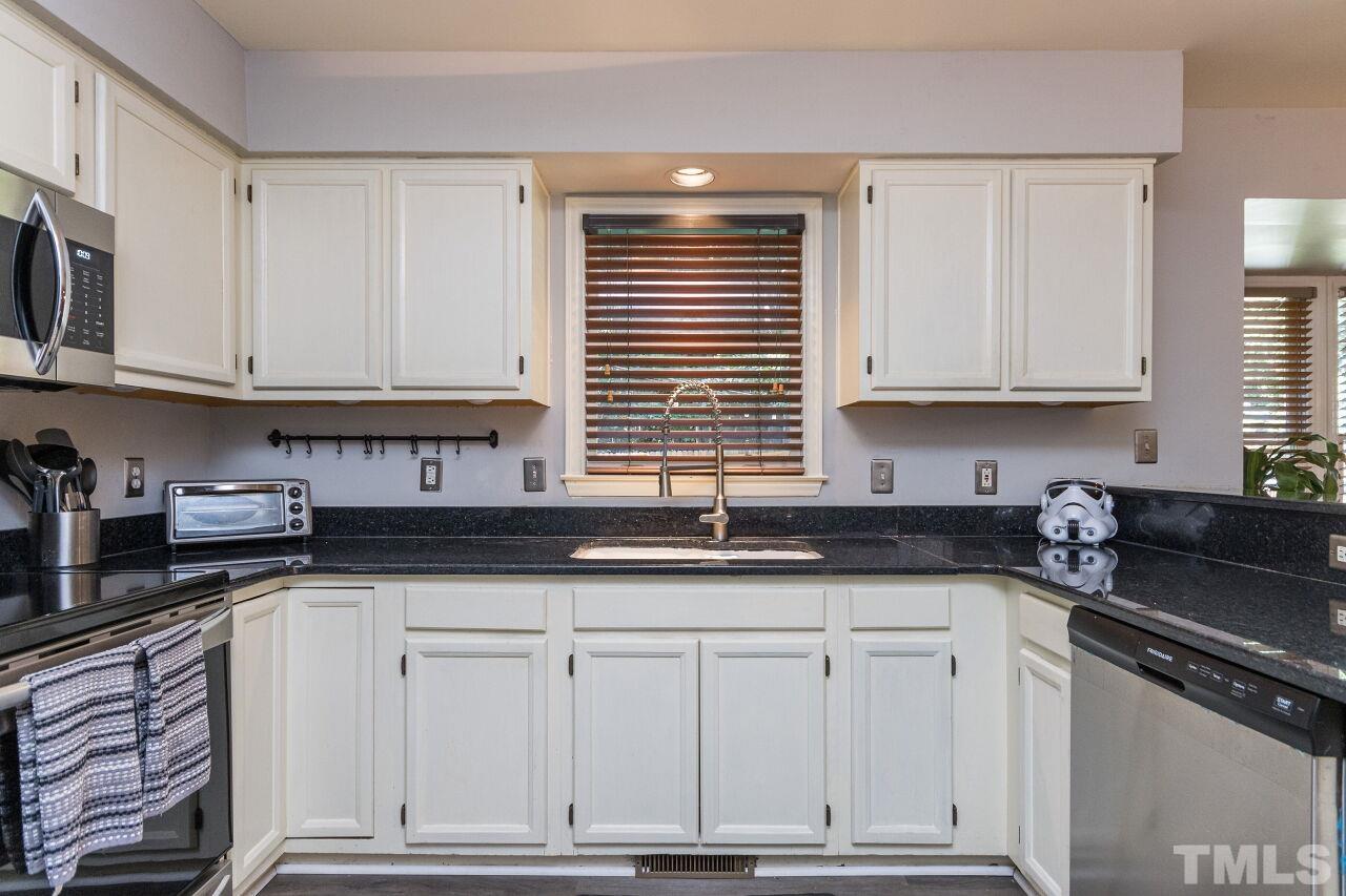 2400 Long And Winding Road Raleigh, NC 27603 - Photo 11 of 29 a kitchen with granite countertop white cabinets and sink