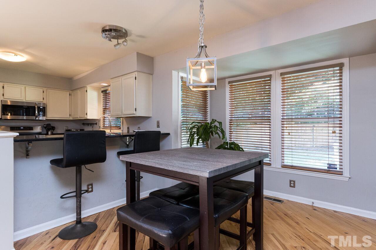 2400 Long And Winding Road Raleigh, NC 27603 - Photo 13 of 29 a view of a dining room with furniture window and wooden floor