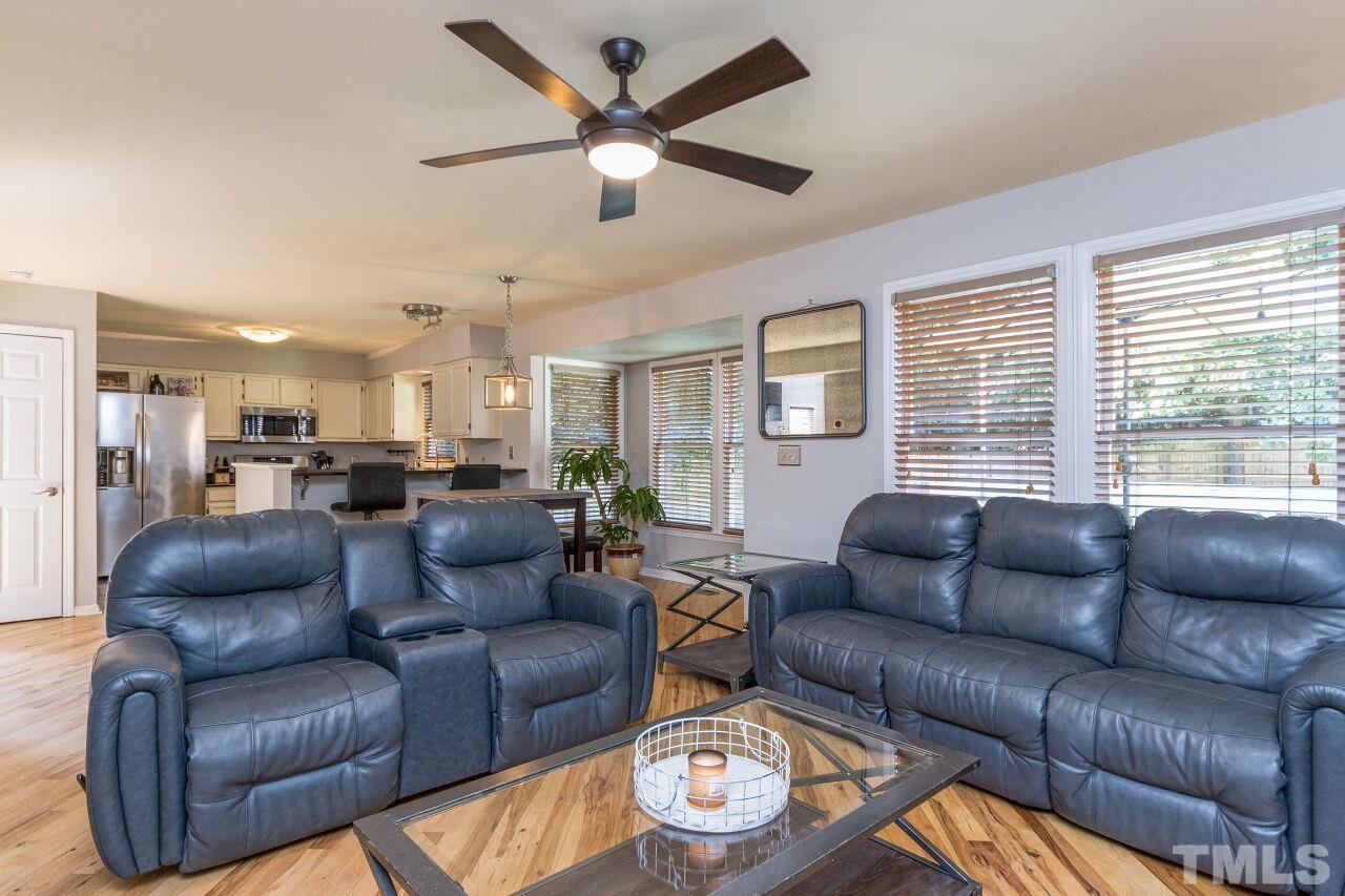 2400 Long And Winding Road Raleigh, NC 27603 - Photo 16 of 29 a living room with furniture ceiling fan and a large window