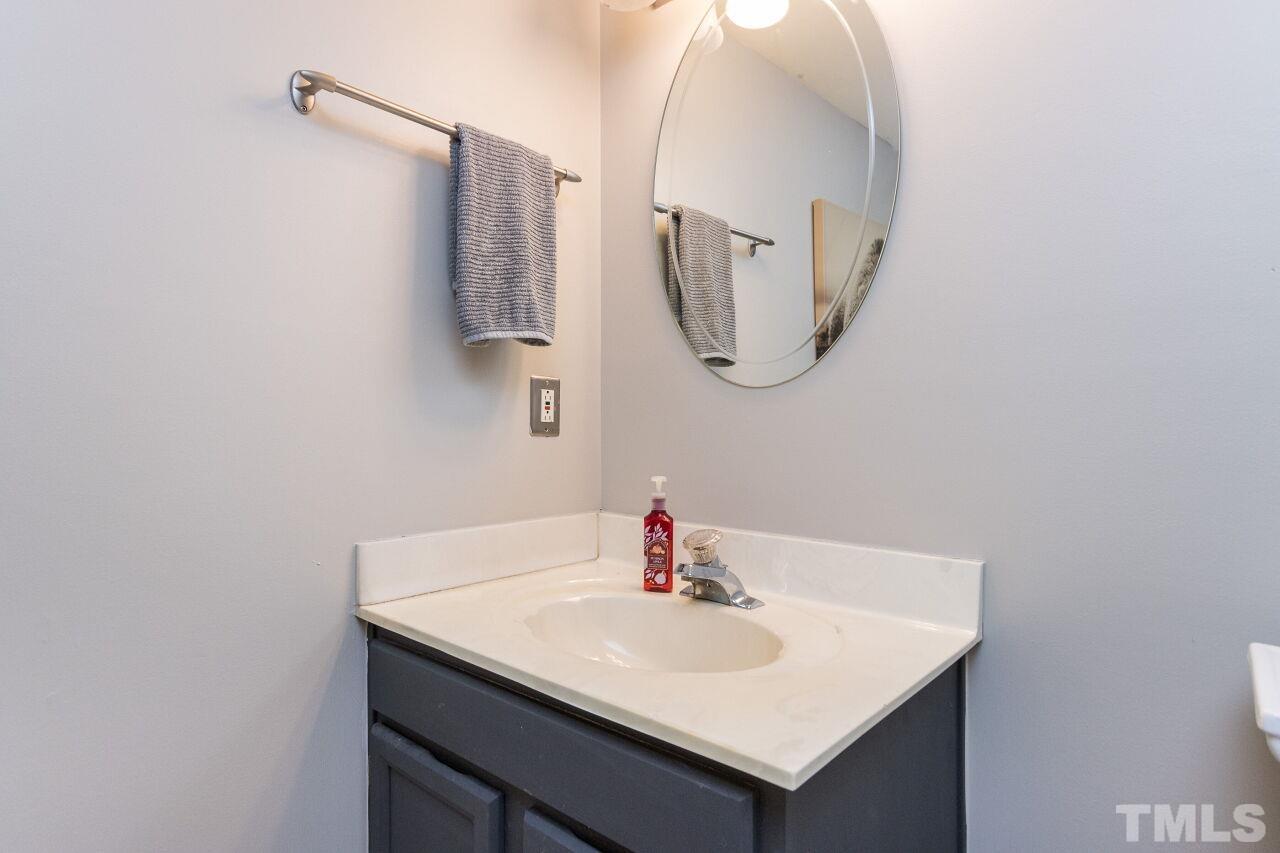 2400 Long And Winding Road Raleigh, NC 27603 - Photo 17 of 29 a bathroom with a sink vanity and a mirror