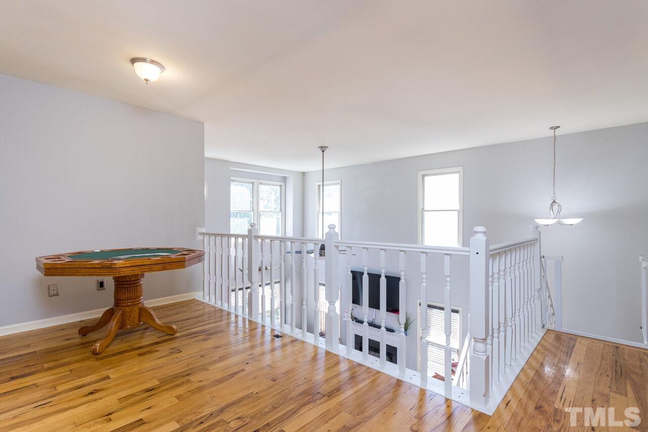 2400 Long And Winding Road Raleigh, NC 27603 - Photo 18 of 29 a view of a room with wooden floor table and chairs