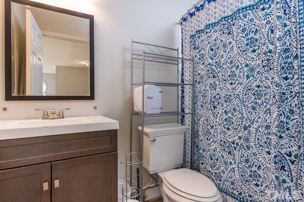 2400 Long And Winding Road Raleigh, NC 27603 - Photo 20 of 29 a bathroom with a toilet sink and mirror