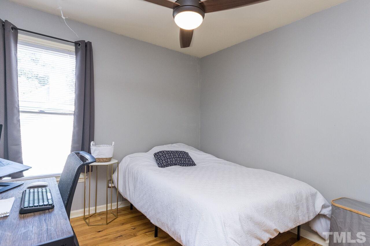 2400 Long And Winding Road Raleigh, NC 27603 - Photo 21 of 29 a bedroom with a bed and wooden floor