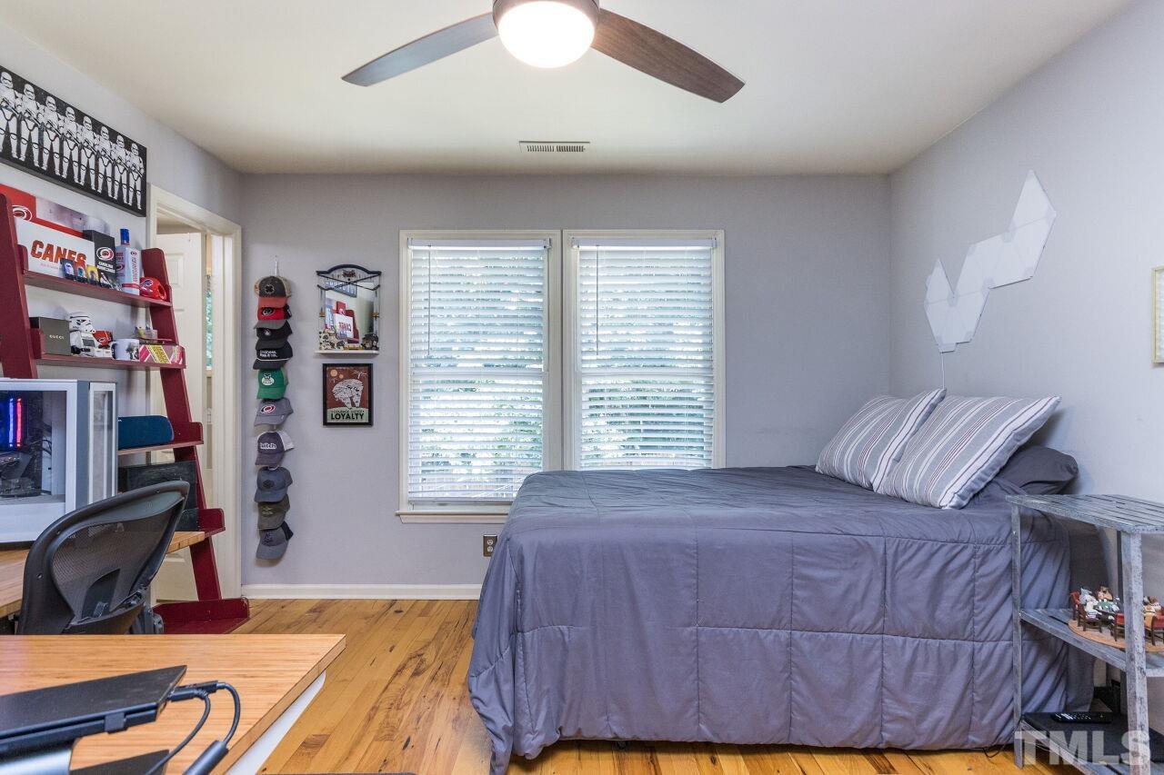 2400 Long And Winding Road Raleigh, NC 27603 - Photo 22 of 29 a bedroom with a bed furniture and a large window