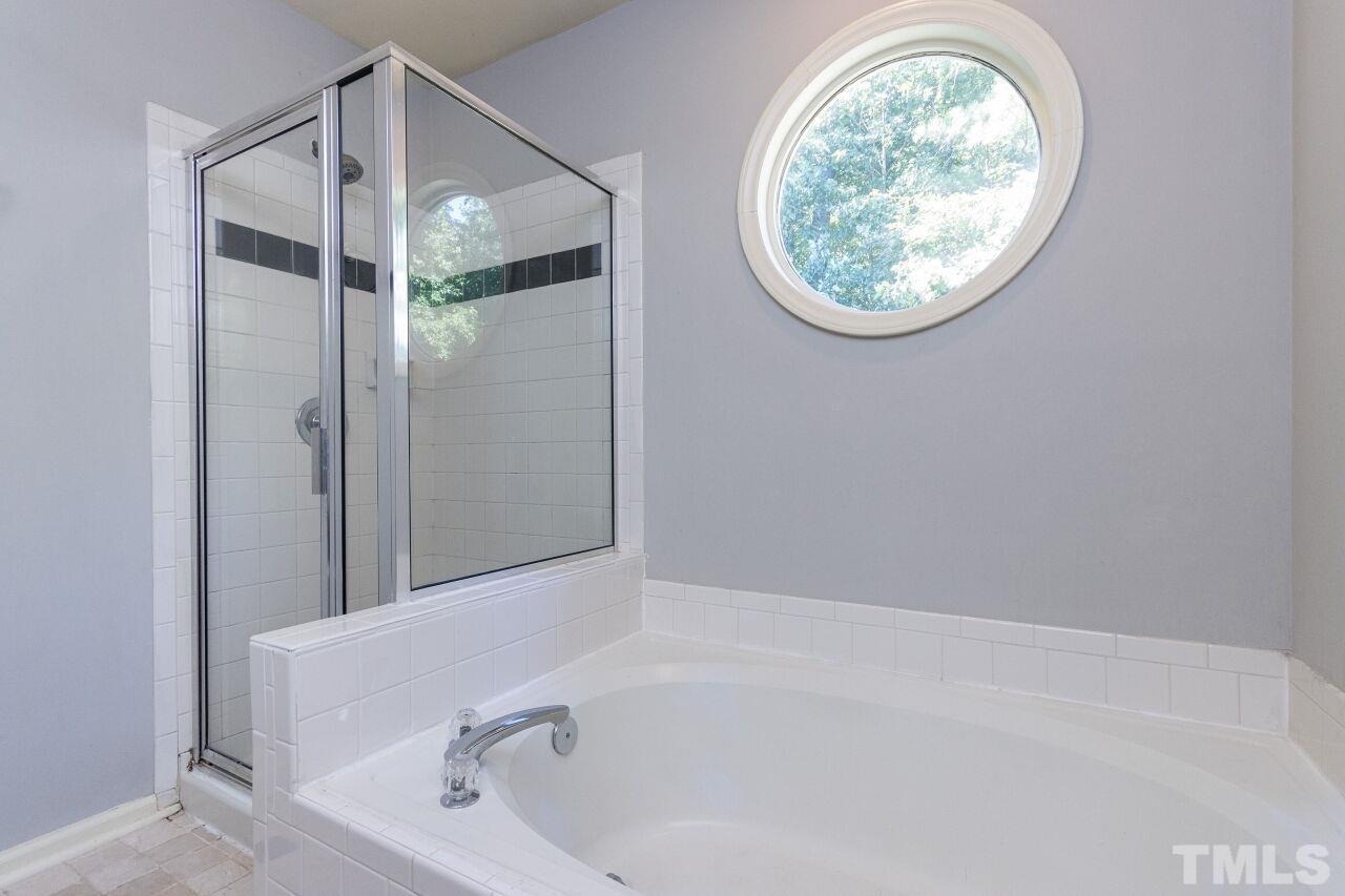 2400 Long And Winding Road Raleigh, NC 27603 - Photo 25 of 29 a bathroom with a tub and a shower