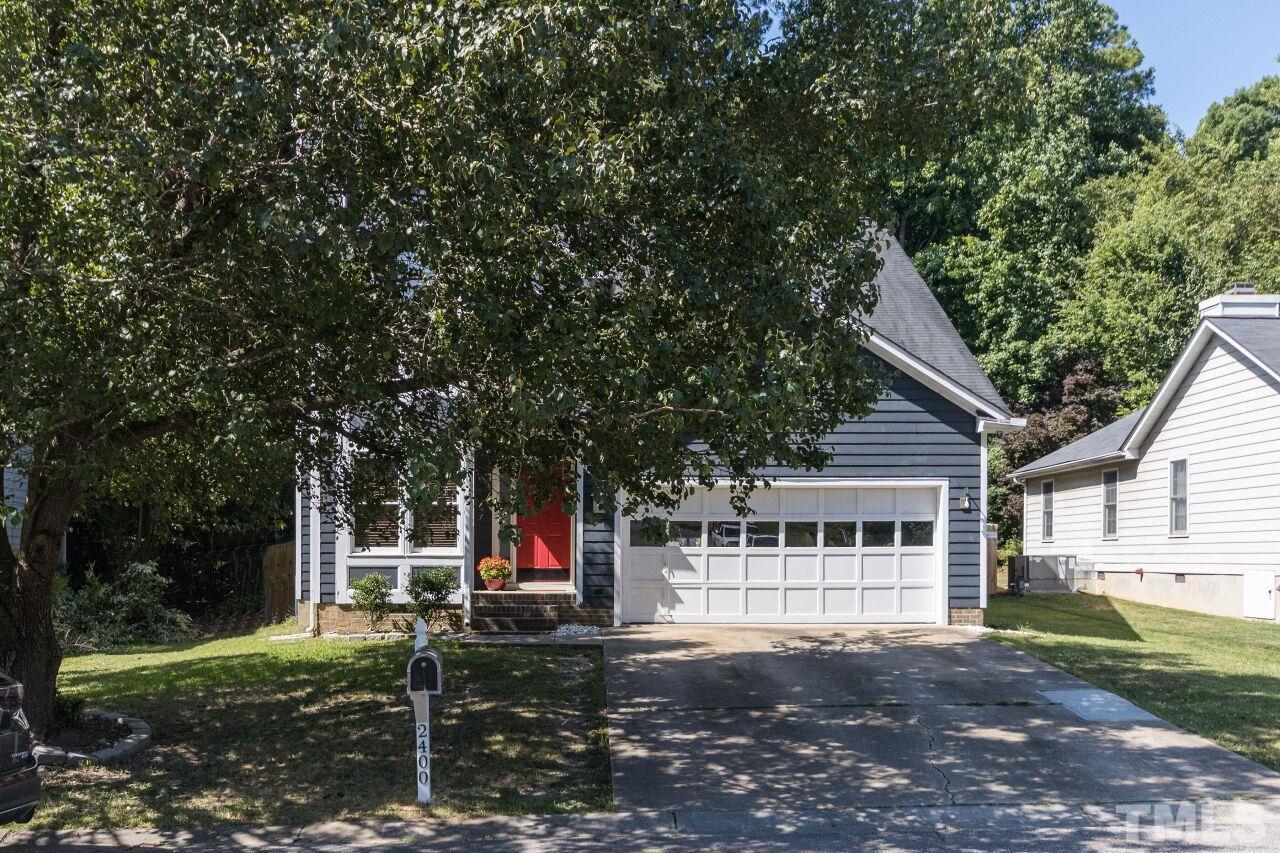 2400 Long And Winding Road Raleigh, NC 27603 - Photo 4 of 29 a view of a house with backyard and trees