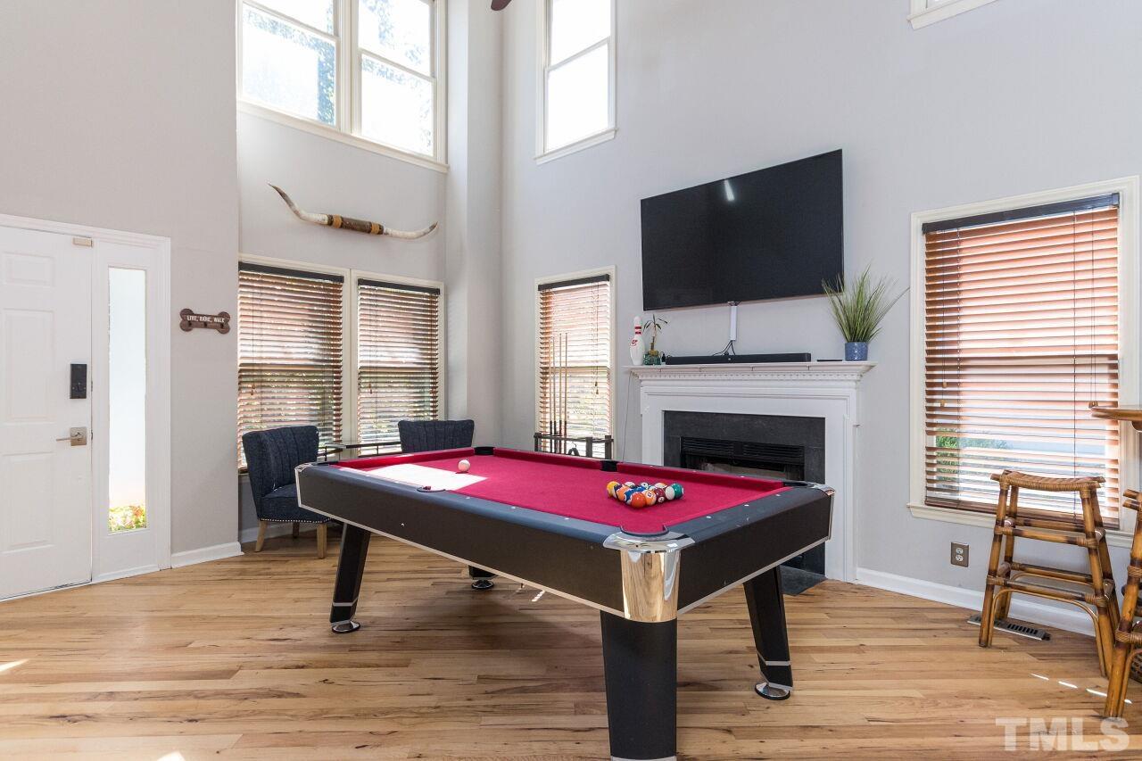 2400 Long And Winding Road Raleigh, NC 27603 - Photo 5 of 29 a patio with a table chairs and a flat screen tv