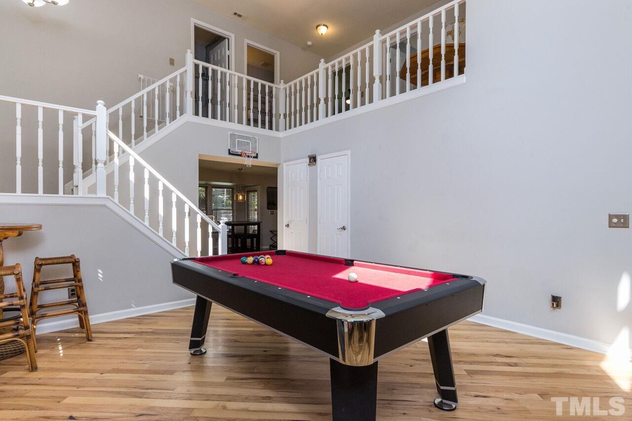 2400 Long And Winding Road Raleigh, NC 27603 - Photo 7 of 29 a living room with furniture pool table and wooden floor