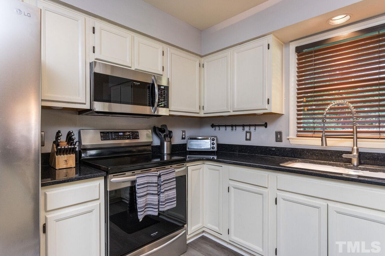 2400 Long And Winding Road Raleigh, NC 27603 - Photo 10 of 29 a kitchen with granite countertop a sink and a stove