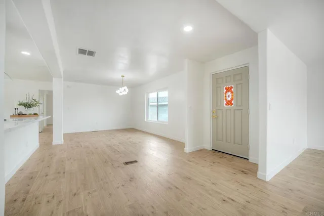 a view of a room with wooden floor and a window
