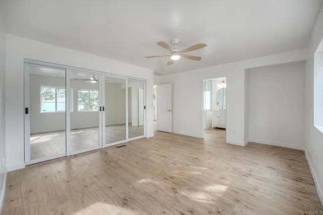 a bathroom with a shower sink vanity and mirror