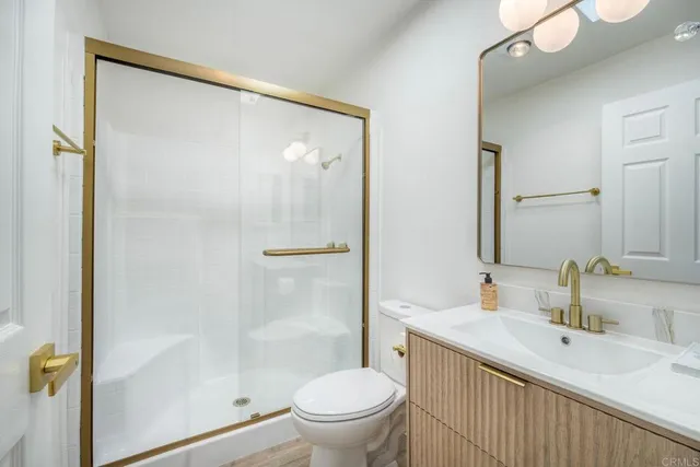 a bathroom with a sink toilet and mirror