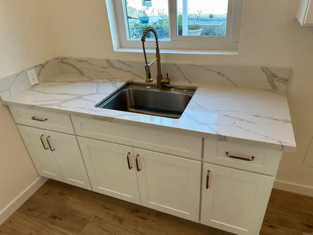 a view of a patio with a table chairs and backyard