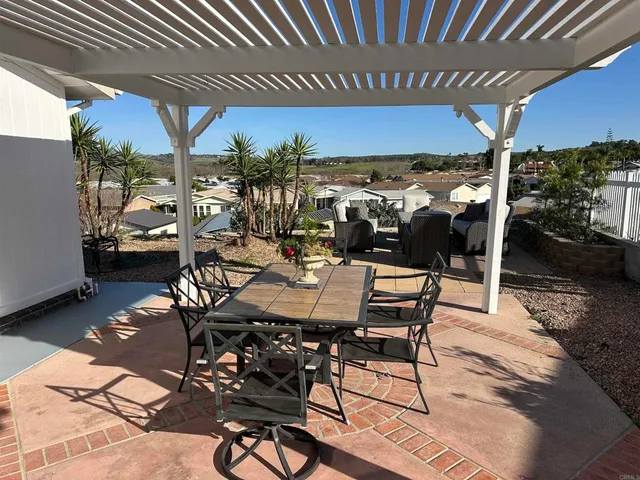 a view of a terrace with furniture and city view