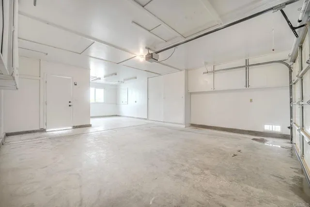 a view of a dry yard with wooden fence