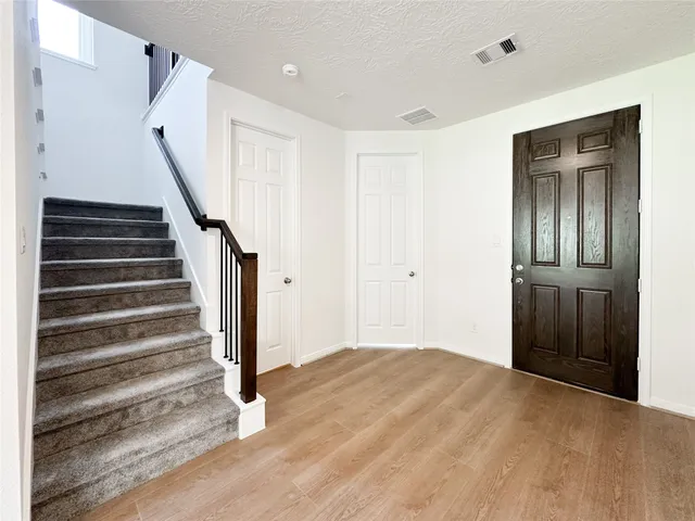 a view of entryway with wooden floor