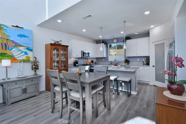 a kitchen with granite countertop a sink stainless steel appliances white cabinets and a granite counter tops