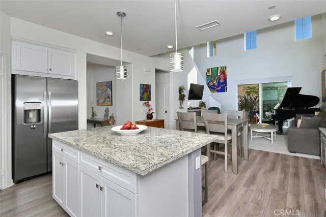 a kitchen with white cabinets and sink