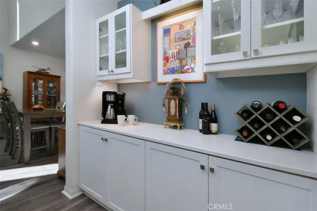 a living room with furniture a rug and a wall painting